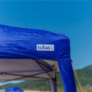Mão fechando o zíper da sacola de transporte da tenda gazebo sanfonada e tenda articulada Tobee.